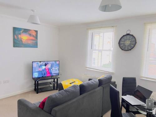 a living room with a couch and a tv at 2 Bedroom Flat in Colchester in Colchester