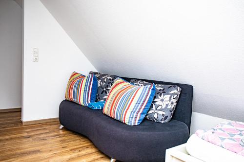 two pillows sitting on a couch in a room at Ferienwohnungen Saida Wohnung 2 in Norden