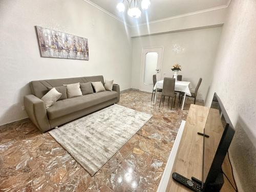 a living room with a couch and a table at Maison Grimaldi Roma in Rome