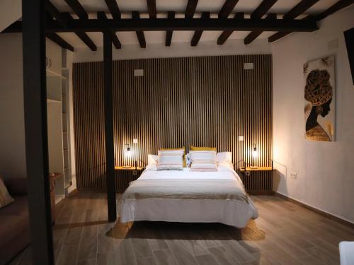 a bedroom with a large bed with two pillows at La Fortaleza Apartamentos Rurales in Hervás