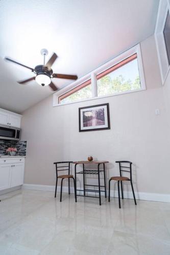a dining room with a table and chairs and a ceiling fan at Pyramid Studio + free parking&wifi/ 5%off in Tampa