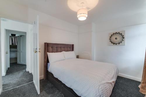 a bedroom with a bed with a white bedspread at K50 Luxury Apartments in Middleton