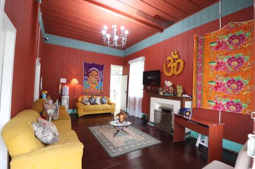 a living room filled with furniture and a fireplace at Pousada Shamballah Paranapiacaba in Paranapiacaba