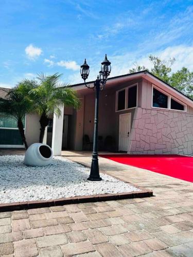 a street light in front of a house with a red carpet at Pyramid Studio + free parking&wifi/ 5%off in Tampa