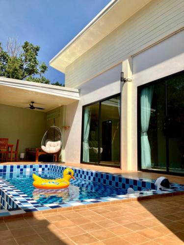 a swimming pool with a rubber duck in the water at Cozy Private Pool Villa For Family - Halal in Ban Thalat Choeng Thale