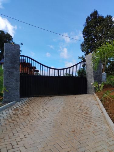 a black iron gate with a brick driveway at Cabanas THE VIEW in Santa Teresa