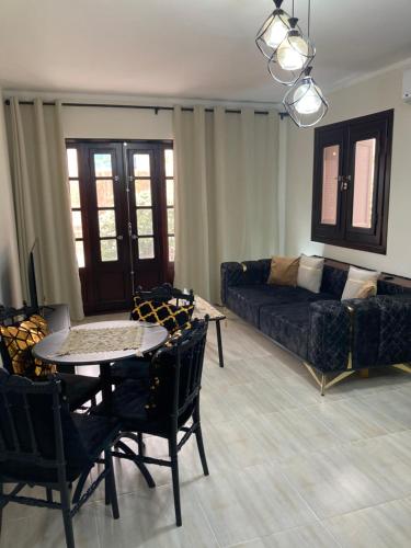 a living room with a couch and a table and chairs at Elite Apartment in Sharm El Sheikh