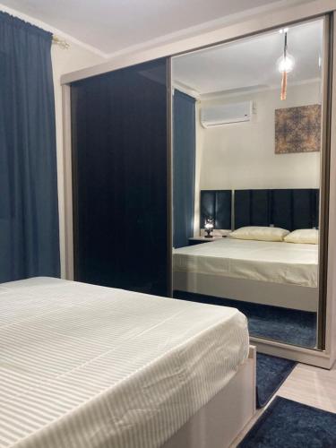 a bedroom with two beds and a large mirror at Elite Apartment in Sharm El Sheikh