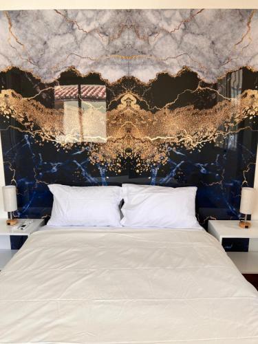 a bedroom with a bed with a blue and gold wall at EMY HOUSE in La Laguna