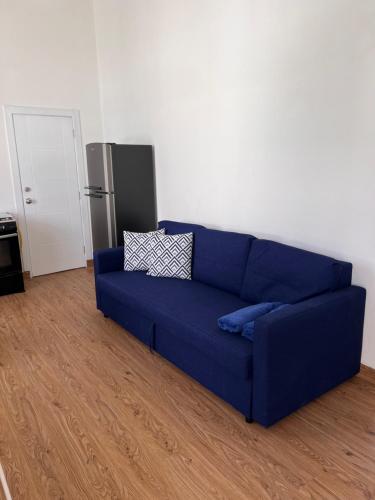 a blue couch sitting in a living room at EMY HOUSE in La Laguna
