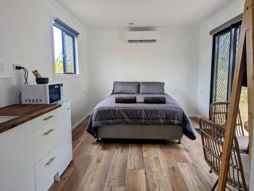 a bedroom with a bed in the middle of it at Trinity Islands Holiday Park - Cabin Accommodation in Burrum Heads