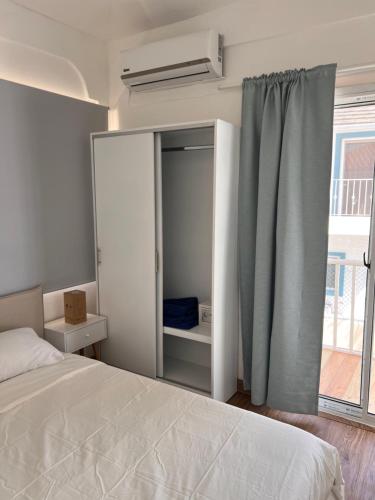 a bedroom with a white bed and a window at EMY HOUSE in La Laguna