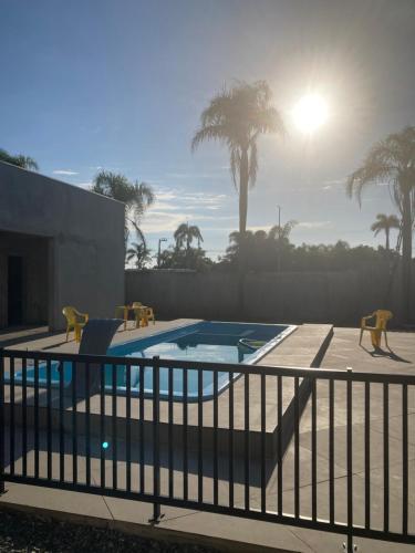 uma piscina com parque infantil e palmeiras em Pousada Barra Coast em Barra Velha