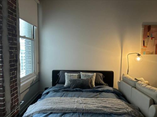 a bedroom with a bed and a window at Downtown Studio Apartment in San Diego