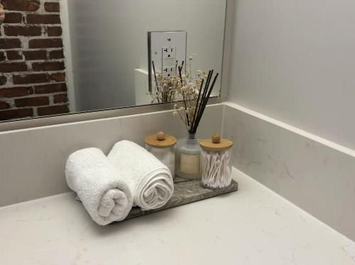 a shelf with towels and a mirror in a bathroom at Downtown Studio Apartment in San Diego
