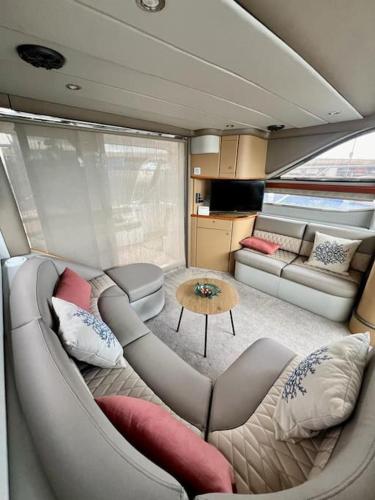 a living room with a couch and a table at Yate Rumbo, casa flotante in Adeje