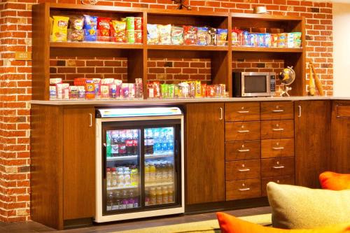 a drink cooler in a kitchen with a brick wall at Four Points by Sheraton Newark Christiana Wilmington in Newark