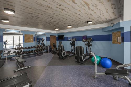 a gym with several treadmills and exercise machines at Four Points by Sheraton Newark Christiana Wilmington in Newark