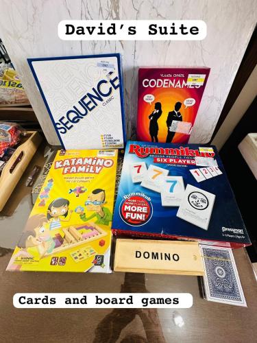 a pile of games and board games on a shelf at Davids Suite at Hope Residences Trece Martires Cavite in Trece Martires