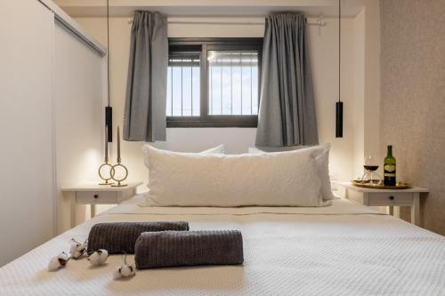 a bedroom with a large white bed with a window at city center apartment in Jerusalem