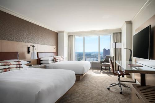 a hotel room with two beds and a desk at Baltimore Marriott Waterfront in Baltimore
