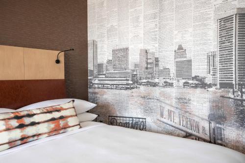 a bedroom with a wall mural of a city at Baltimore Marriott Waterfront in Baltimore