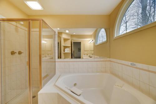 a large bathroom with a tub and a shower at Cozy Mountain & Lake Escape: Perfect for Groups in Lake Harmony