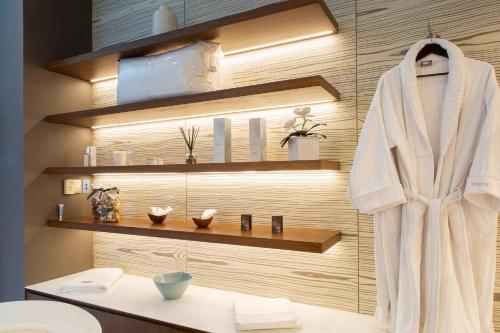 a bathroom with a white robe hanging on a wall at The Westin Santa Fe, Mexico City in Mexico City