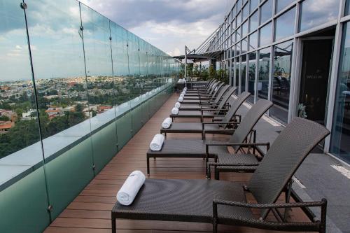 a row of chairs sitting on the roof of a building at The Westin Santa Fe, Mexico City in Mexico City