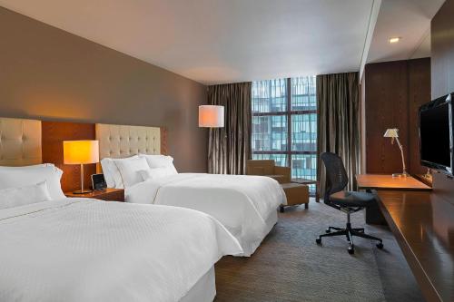 a hotel room with two beds and a television at The Westin Santa Fe, Mexico City in Mexico City