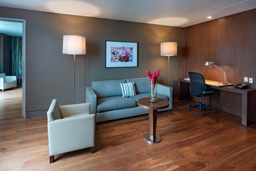 a living room with a couch and a desk at The Westin Santa Fe, Mexico City in Mexico City