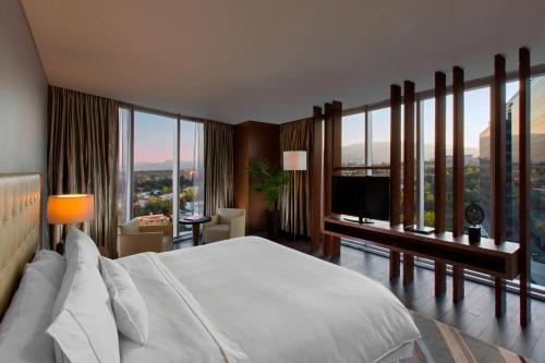 a bedroom with a large bed and a television at The Westin Santa Fe, Mexico City in Mexico City