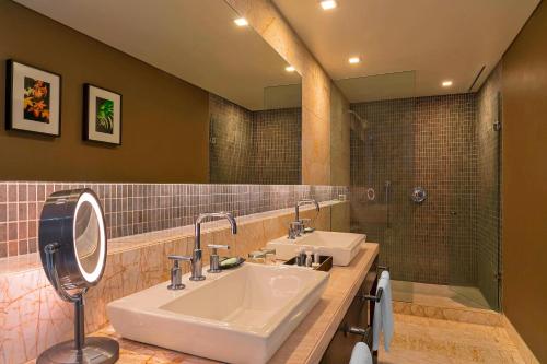 a bathroom with two sinks and a shower at The Westin Santa Fe, Mexico City in Mexico City