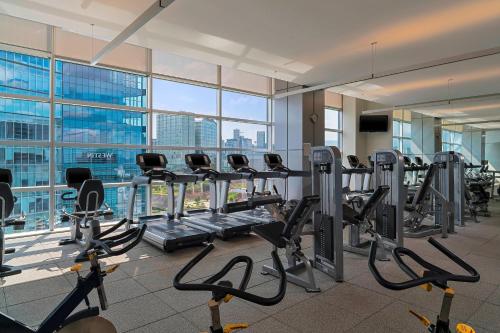 a gym with cardio equipment in a building with a view at The Westin Santa Fe, Mexico City in Mexico City