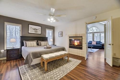 a bedroom with a large bed and a fireplace at Cozy Mountain & Lake Escape: Perfect for Groups in Lake Harmony