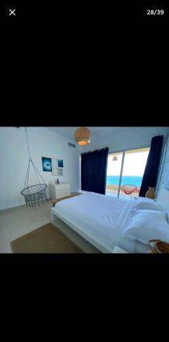 a bedroom with a large bed with a view of the ocean at OCEANFRONT LUXURY IN JUAN DOLIO in Juan Dolio