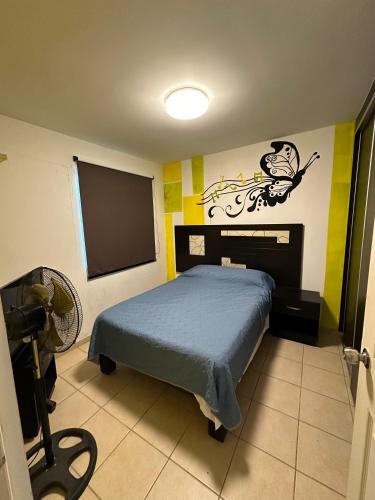 a bedroom with a bed and a flat screen tv at Alojamiento privado con seguridad 1 in Tepic