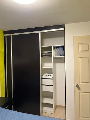 a room with a closet with a black door at Alojamiento privado con seguridad 1 in Tepic