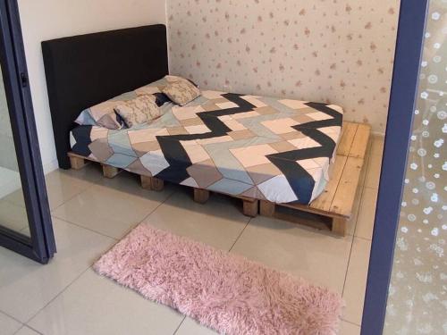 een klein bed in een kamer met een tapijt bij Modern & Homely CBD Private Suite with Pool & Gym in Petaling Jaya