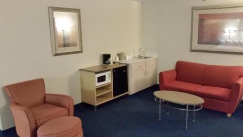 a living room with two chairs and a table at Days Inn by Wyndham Buena Park in Buena Park