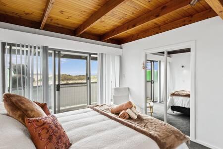 a bedroom with a bed with a view of the ocean at 2-Person Surf Beach Studio App in Surf Beach