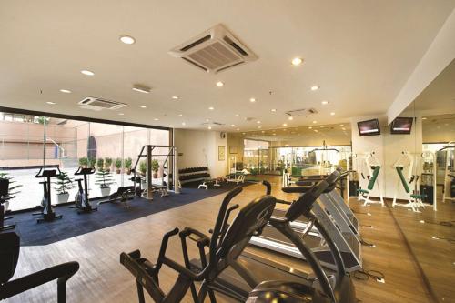a gym with treadmills and machines in a room at Bunga Suite at Times Square in Kuala Lumpur