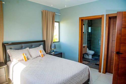 um quarto com uma cama e uma casa de banho com um chuveiro em Beautiful Village 3 bedrooms Furnished Pool residencial Velero punta cana em Punta Cana