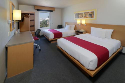 a hotel room with two beds and a desk at City Express by Marriott Tepotzotlán in Tepotzotlán