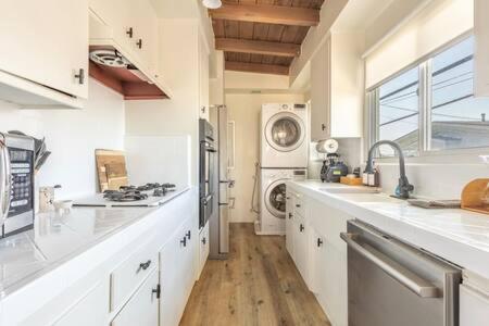 a large kitchen with white counters and a sink at Steps to Beach Manhattan Beach 2 Bedroom Parking in Manhattan Beach