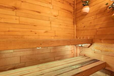a wooden room with a wooden bench in a sauna at Manhattan Beach as your Backyard The Strand in Manhattan Beach