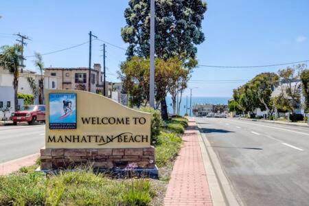 a sign for the welcome to manhattan beach on a street at Manhattan Beach as your Backyard The Strand in Manhattan Beach