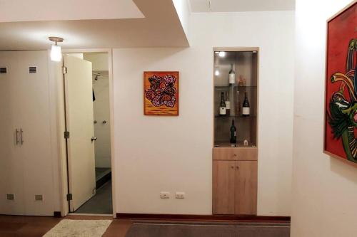 a hallway with a door leading to a room with a mirror at Excellent apartment, access to pool, grills, ballroom in Lima