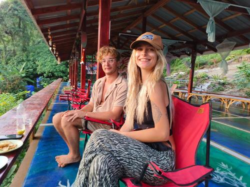 a man and a woman sitting on a train at SZ Samui Glamping in Ban Sa Ket