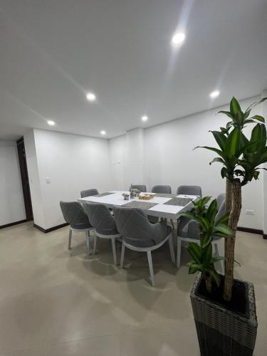 a conference room with a table and chairs and a potted plant at The Edge Luxury Home in Tunja